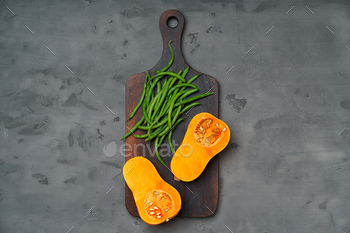Raw orange pumpkin and wooden cutting board / Photodune, Misc