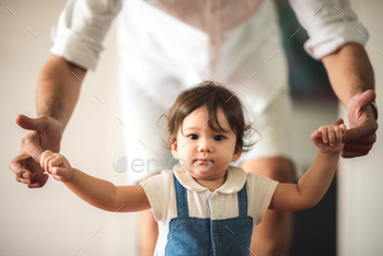 cute toddler little child family concept, baby learning to walk with father and mother to help care / Photodune, Misc