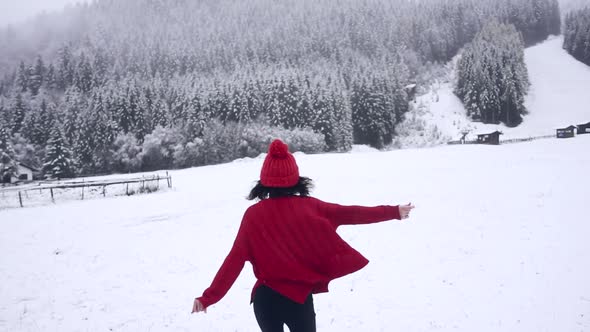 Happy Girl Running in Snowfall in Slow Motion