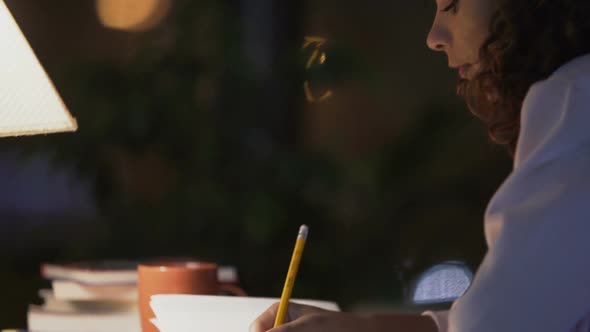 Curly-Haired Girl Sitting in Cafe, Writing a Diary About Her Dreams and Memories