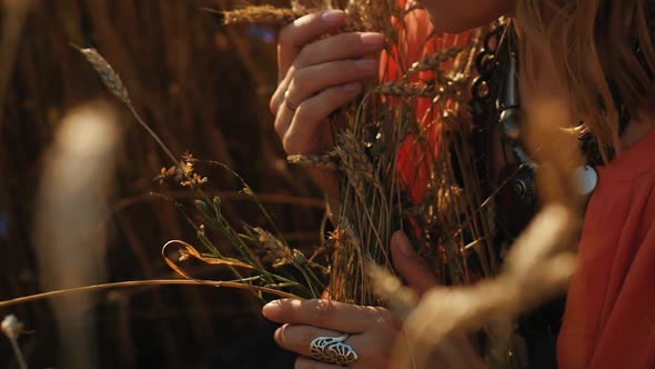 Portrait of a Blonde Hippie Girl with Ears of Wheat in Her Hands