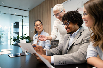 Happy business people having fun and chatting at workplace office / Photodune, Misc