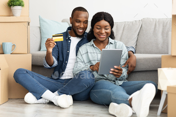 it Card Choosing Furniture Online After Moving To New Apartment, Smiling Young Black Couple With Tab Computer Shopping In Internet, Free Space
