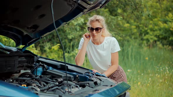 Woman Repairing Accident Car.Sad Disappointed Woman On Broken Car.Fix Car Engine Overheating.