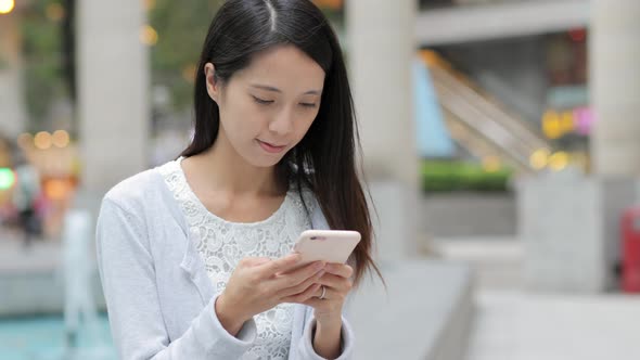 Woman use of cellphone in Hong Kong city