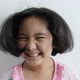Slow motion shot of Happy Asian girl playing with hair blowing on white background. - VideoHive Item for Sale