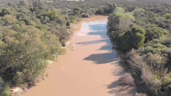 aerial birds eye view following a river after some rainfall