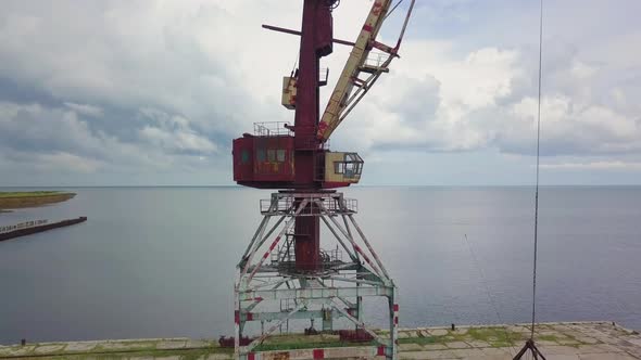 An Old Abandoned Rusty Crane in the Seaport