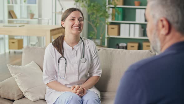 A Friendly Medical Professional Takes Care of a Middleaged Man at Home