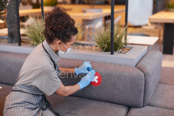 Woman Putting Social Distancing Sticker / Photodune, Misc