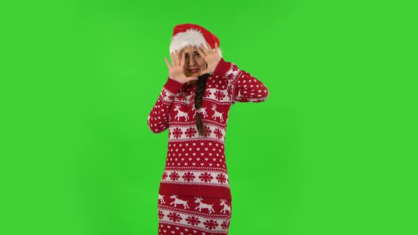 Sweety Girl in Santa Claus Hat with Fear and Horror Looking Forward. Green Screen