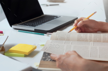 Woman reading a book. / Photodune, Misc