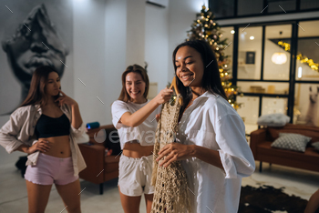 Beautiful girls choose their clothes at home / Photodune, Misc