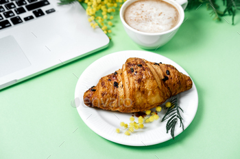 Woman work space with laptop, mimosa flower, croissant, coffee and stationery / Photodune, Misc