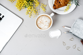 Woman work space with laptop, mimosa flower, croissant, coffee and stationery / Photodune, Misc