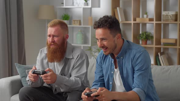 Caucasian Friends With Joystick Playing Video Games At Home