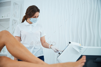 preparing a female customer for a cosmetic procedure