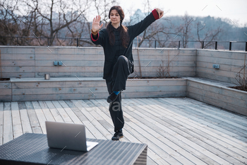 Woman outdoors standing in kung fu crane stance / Photodune, Misc