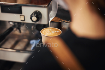 Skillful barista making a leaf design on latte surface / Photodune, Misc