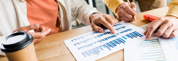 cropped view of businesspeople analyzing graphs and charts in office / Photodune, Misc