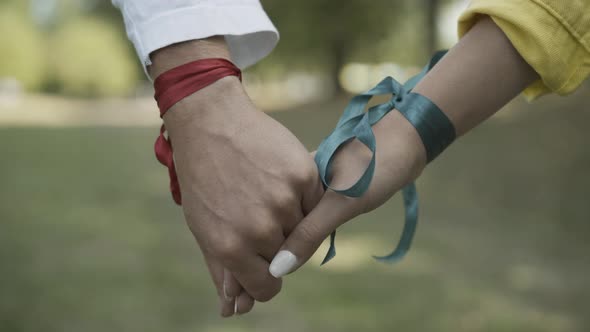 Closeup Male Female Caucasian Hands Ribbons Sunlight