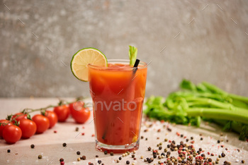 selective focus of bloody mary cocktail in glass with straw and lime near salt, pepper, tomatoes and / Photodune, Misc