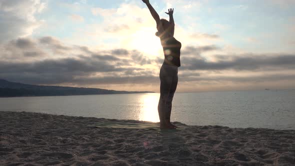Woman practicing yoga on the beach. Outdoors sports. Healthy living.