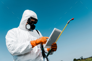 man in protective mask and uniform pointing with finger at digital tablet against sky / Photodune, Misc