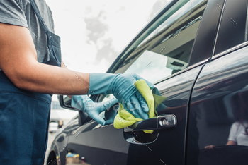 cropped view of car cleaner wiping car door with rag / Photodune, Misc