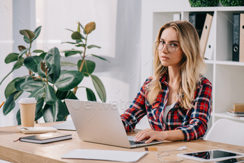 portrait of businesswoman using laptop while taking part in webinar / Photodune, Misc