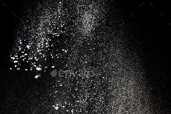 Flour sifting on a black background. White powder splash isolated on black background / Photodune, Misc