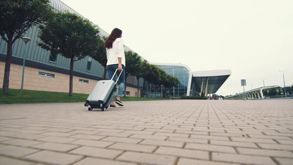 Woman Walking with Luggage. The Girl Goes on a Journey and Walks To the Airport. A Businesswoman