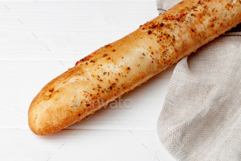 Fresh baguette bread on white wooden table / Photodune, Misc