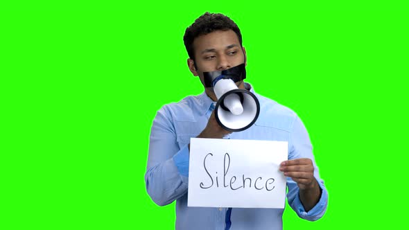 Man with Taped Mouth Trying To Speak in Megaphone