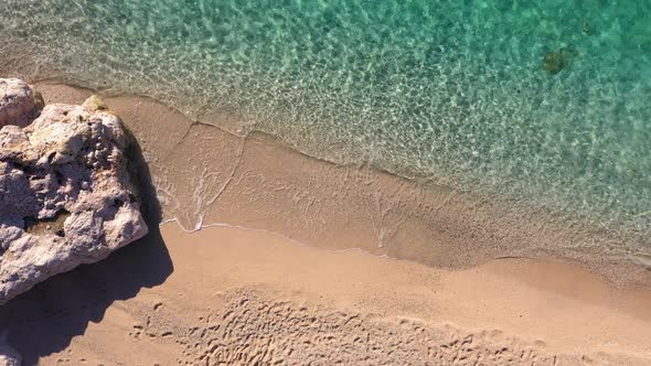 Aerial View of Beautiful Tropical Beach and Rocky Coastline with Ocean Waves