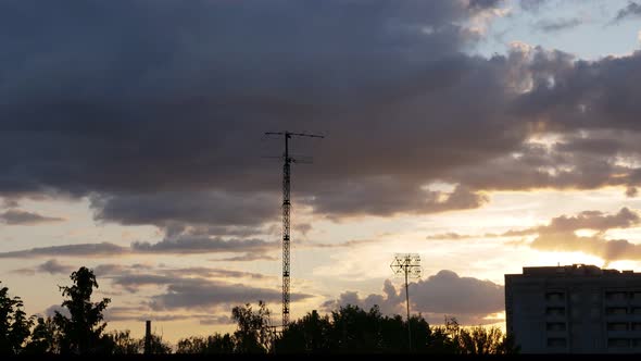 Timelapse, Beautiful Orange Sunset in the City. Running Gray, Rain Clouds.