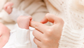 Closeup shot of little newborn baby hand holding big finger of young mother - PhotoDune Item for Sale