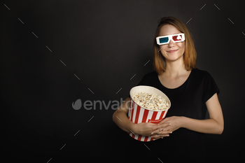 young beautiful woman with bucket of popcorn isolated on black / Photodune, Misc