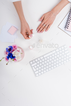 partial top view of young woman doing french manicure at workplace / Photodune, Misc