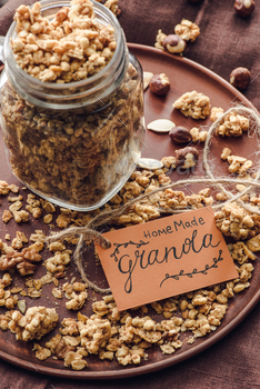 overhead view of homemade tasty granola in glass jar with tag on tray / Photodune, Misc
