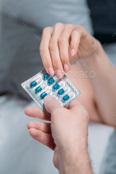 cropped shot of female and male hands holding medicines together / Photodune, Misc