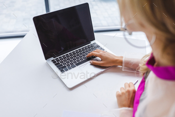 cropped view of woman using laptop with blank screen / Photodune, Misc