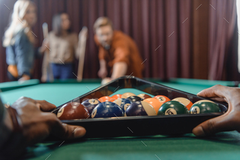 cropped image of male hands forming set of billiard balls by triangle / Photodune, Misc