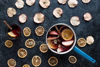 Top view of water dipper and glass with homemade mulled wine among dried fruits / Photodune, Misc