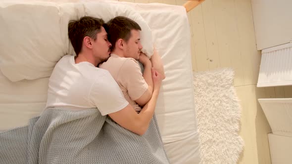 Happy Gay Couple Lying on Bed at Home