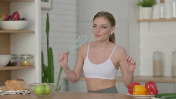 Healthy Woman Dancing While Cooking in Kitchen