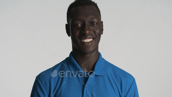 Portrait of African American man smiling broadly on camera over white background. Happy expression / Photodune, Misc
