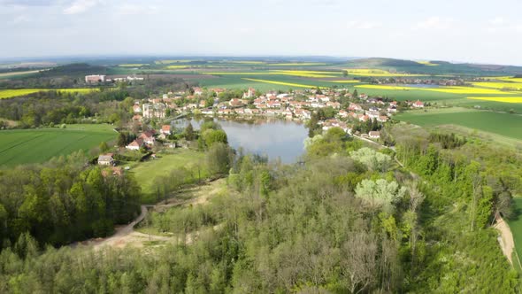 Aerial Drone Shot  a Picturesque Village Surrounded By Fields By a Lake in a Rural Area