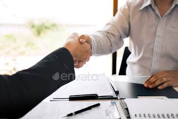 Manager and employee interview concept with handshake after talking about contract signing. / Photodune, Misc