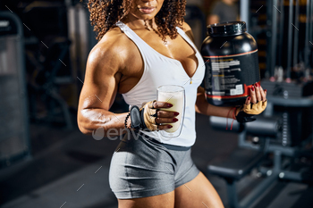 African American lady holding her protein shake / Photodune, Misc